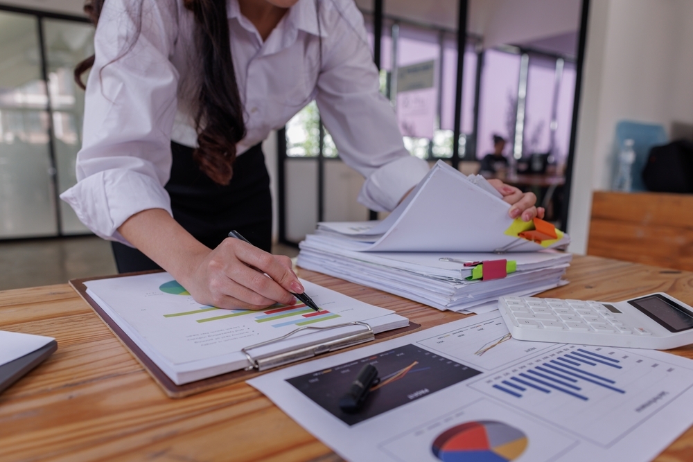 A forensic accountant reviewing financial documents.