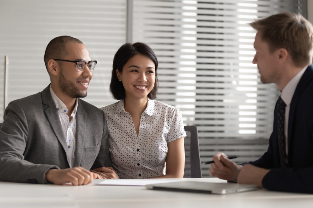 a wealthy couple discussing the difference between a family office and a wealth advisory firm with their CPA