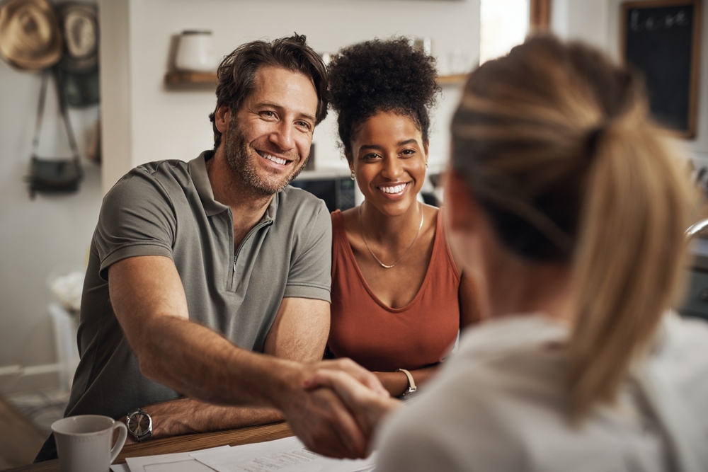 couple shaking hands with a CPA meeting to discuss HSA Contribution Limits and Deadlines for 2024  