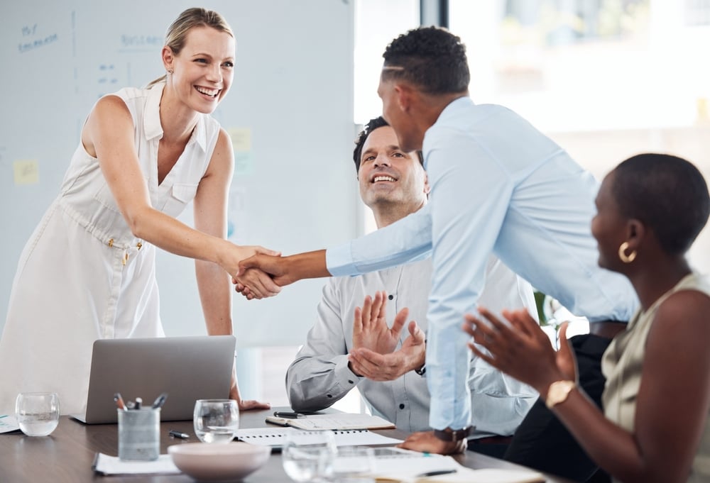 two business professionals shaking hands after a successful merger or acquisition discussion, supported by accounting services