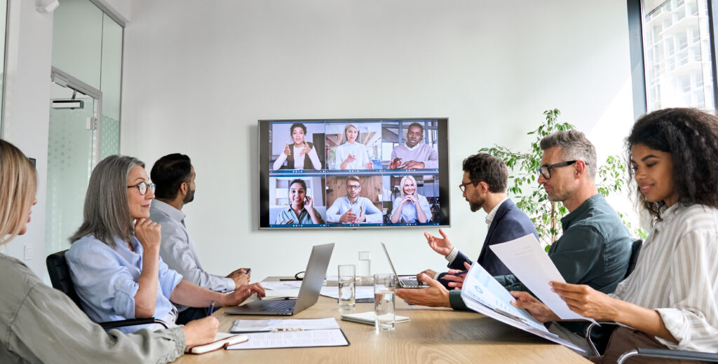 company executives on a video call with a new merging acquisition to discuss accounting