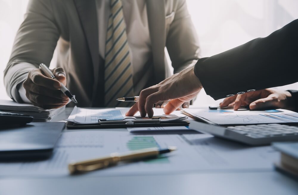 Business team meeting present, investor colleagues consultation and conference new strategy plan business and market growth on financial document graph report, Meeting and Talking.