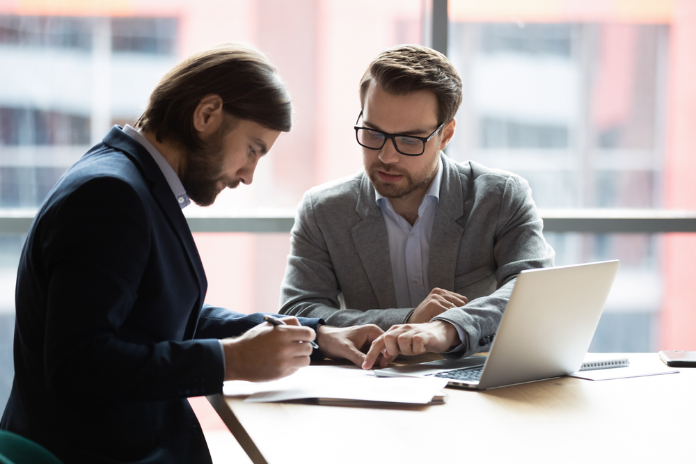 business owner and fractional cfo going over business paperwork together